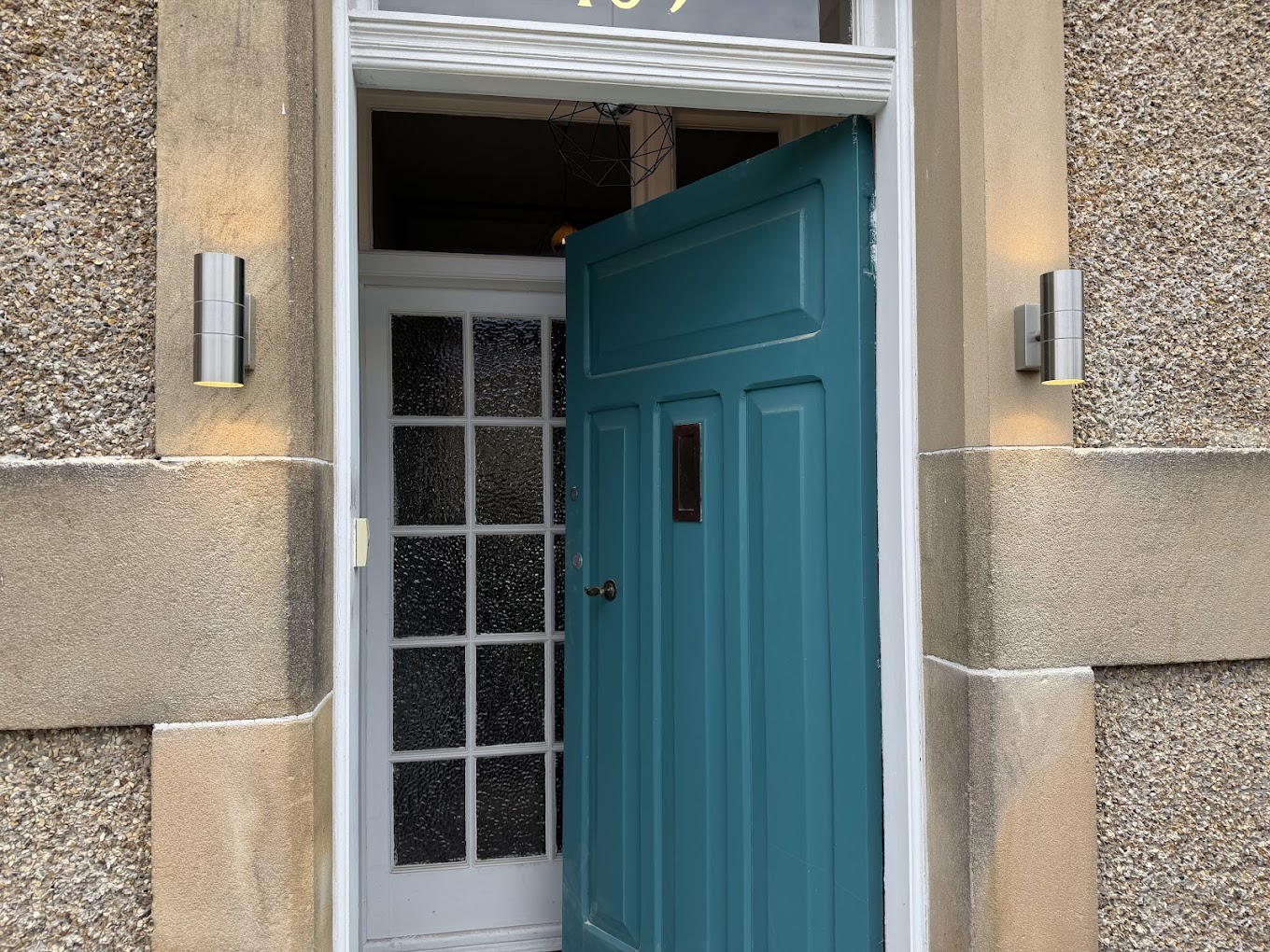 New exterior wall lights installed at a front door